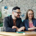 two people sitting at a desk learning about better jobs ontario